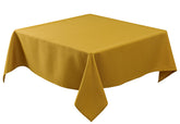 Mantel Biscaynebay con textura dorada para un comedor elegante y formal.