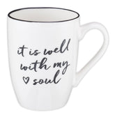 Taza It Is Well de Christian Art Gifts con borde negro para uso diario.