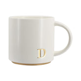 COLLECTIVE HOME taza monograma oro 15oz, ideal para empezar el día con estilo.