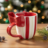 Taza navideña DIF DECO de cerámica con lazo, ideal para cacao caliente.