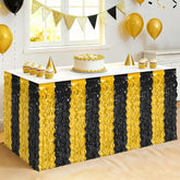 Huskein faldas de mesa metalizadas en negro y dorado para un brillo elegante.