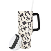 JarThenaAMCS vaso aislante con diseño lazo negro sobre beige, perfecto para uso diario.