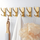 Ganchos autoadhesivos Pickpiff dorados para pared, ideales para espacios sin taladro.