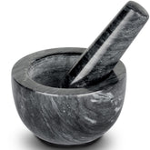 Tera mortero y pilón de mármol negro, ideal para moler especias.