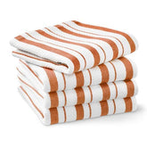 Toallas rayadas Williams-Sonoma en naranja calabaza, suaves y absorbentes para manos y superficies.