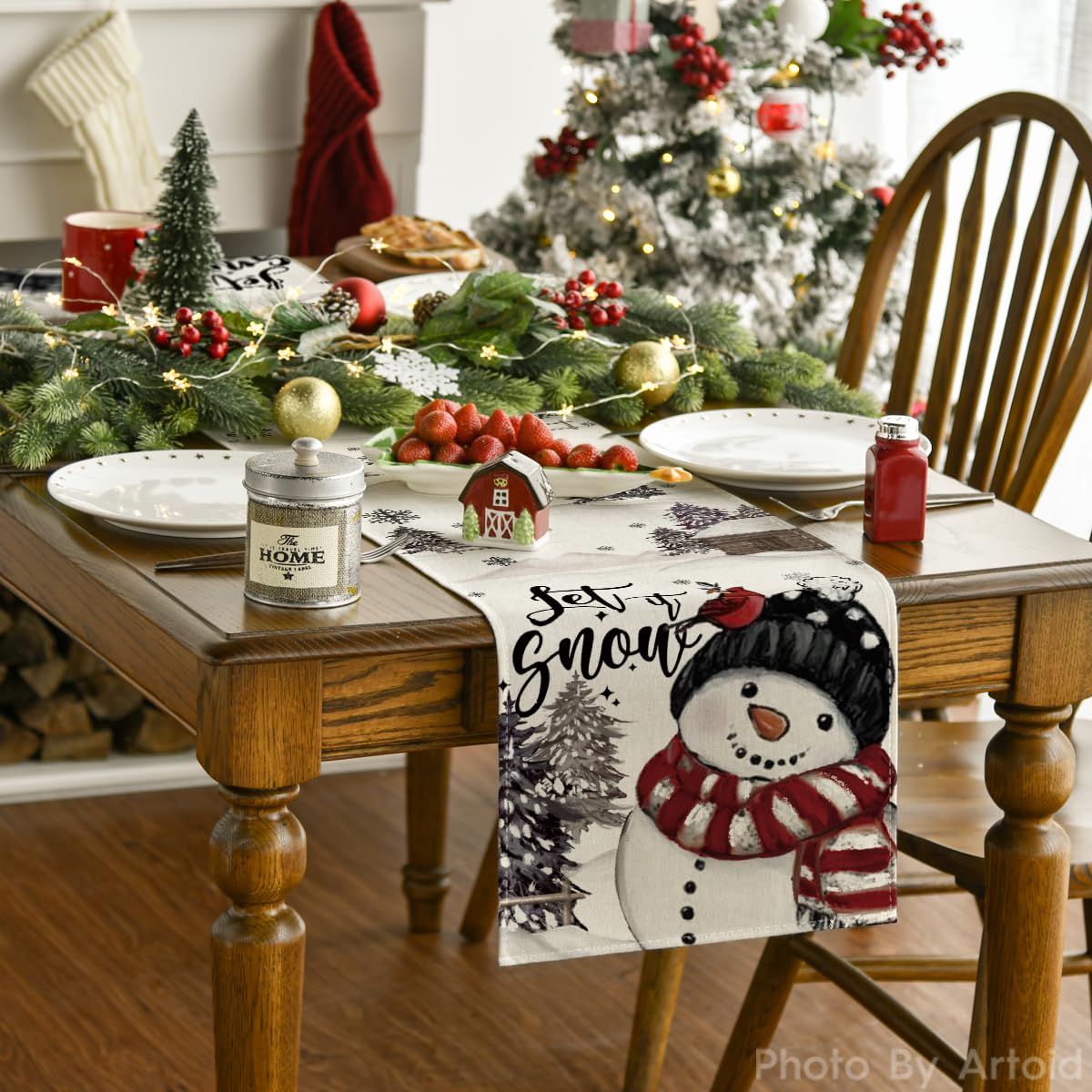Mantel Artoid Mode con muñeco de nieve negro para decorar la mesa festiva.