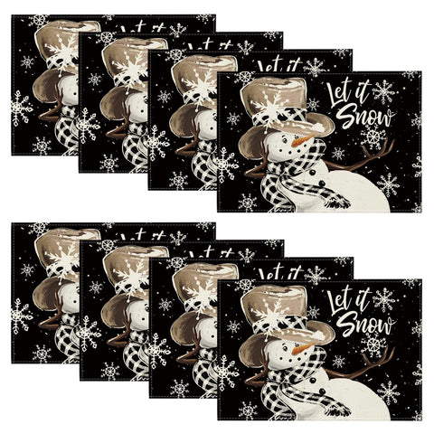 Artoid Mode muñéco de nieve negro y copos de nieve en el mantel, ideal para fiestas.