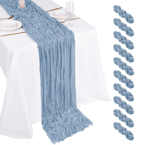 Mantelería Beautane de gasa azul polvoriento decora la mesa de bodas