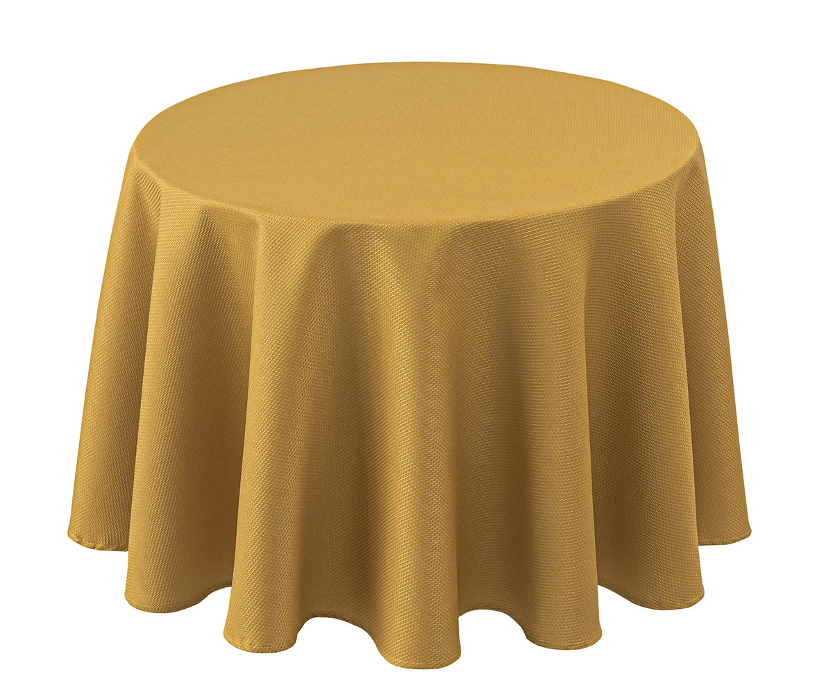 Mantel Biscaynebay redondo con textura dorada, añade elegancia a la mesa.