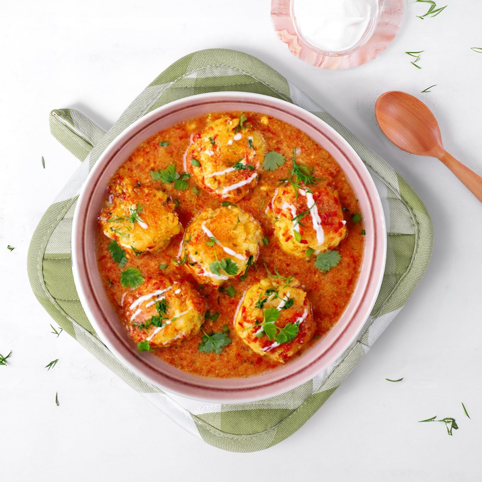 Almohadillas salvamanteles BONTHEE en verde a cuadros para superficies protegidas.