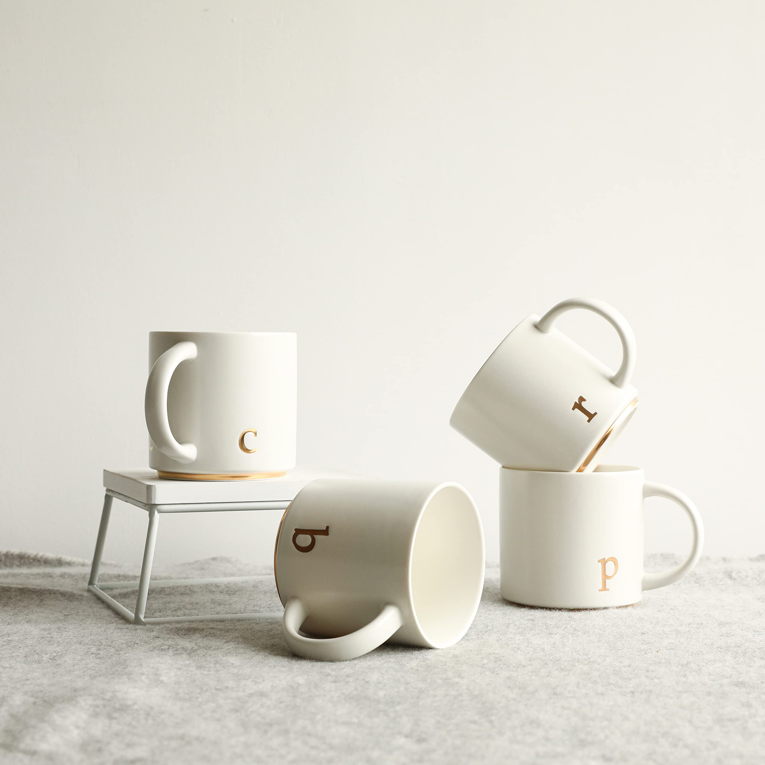 COLLECTIVE HOME, diseño de monograma dorado en taza cerámica