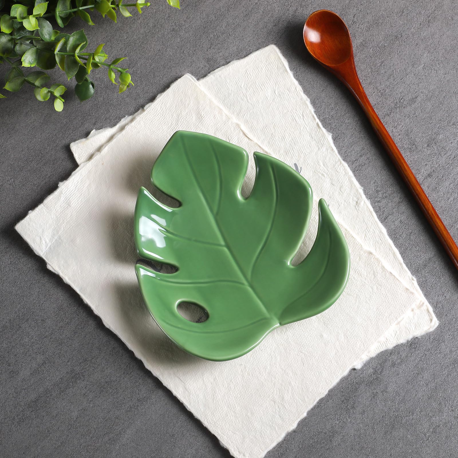Honeydak Monstera hoja cerámica, destacando en la mesa.