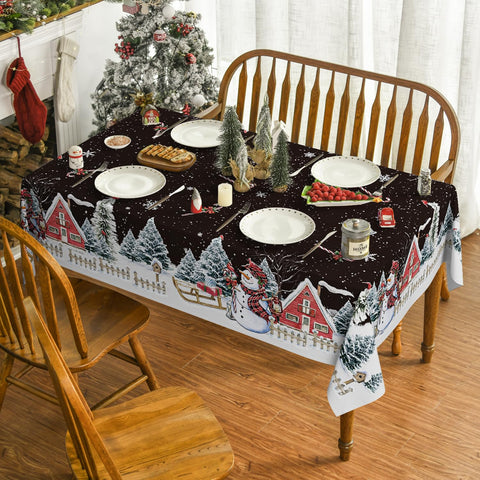 Detalle de casita de nieve con copos y Horaldaily para la mesa navideña.