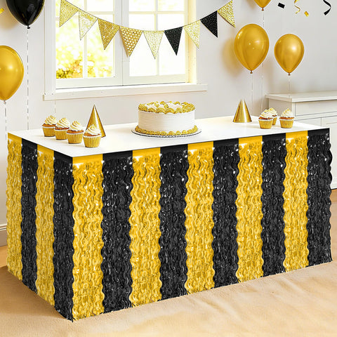 Huskein faldas de mesa metalizadas en negro y dorado para un brillo elegante.