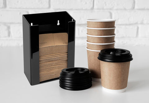 Inevibe dispensador vertical negro para mangas de café en mostrador.