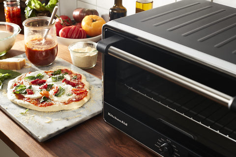 KitchenAid KCO124BM fits two full chickens; versatile countertop cooking.