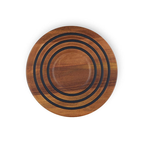 Le Creuset trivet magnético de madera de acacia en uso para servir.