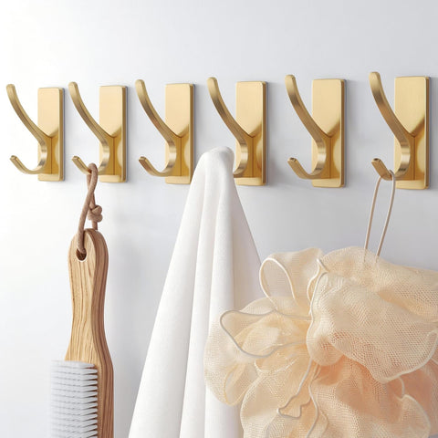 Ganchos autoadhesivos Pickpiff dorados para pared, ideales para espacios sin taladro.