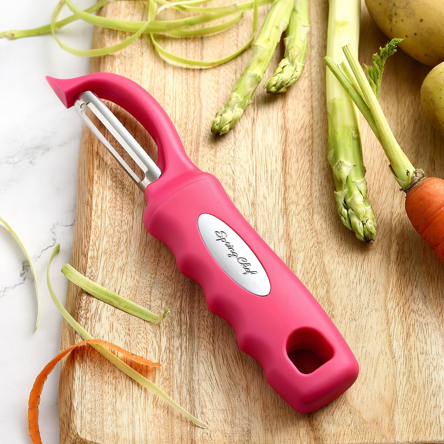 Spring Chef pelador rosado deslizamiento suave para pelar sin esfuerzo.