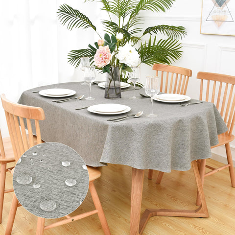 Mantel oval gris de Trczzone con textura simulada de lino, protege la mesa y añade elegancia moderna.