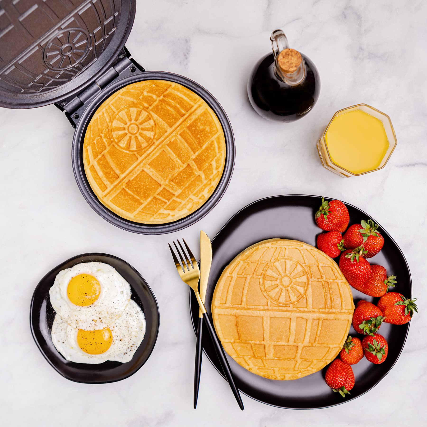 Gofrera Uncanny Brands Estrella de la Muerte vertiendo masa para waffles crujientes.