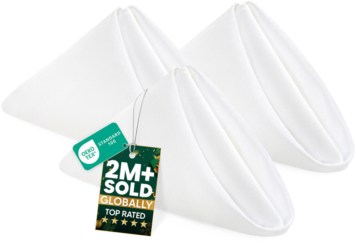 Servilletas blancas de Utopia Home extendidas sobre mesa para presentación elegante.